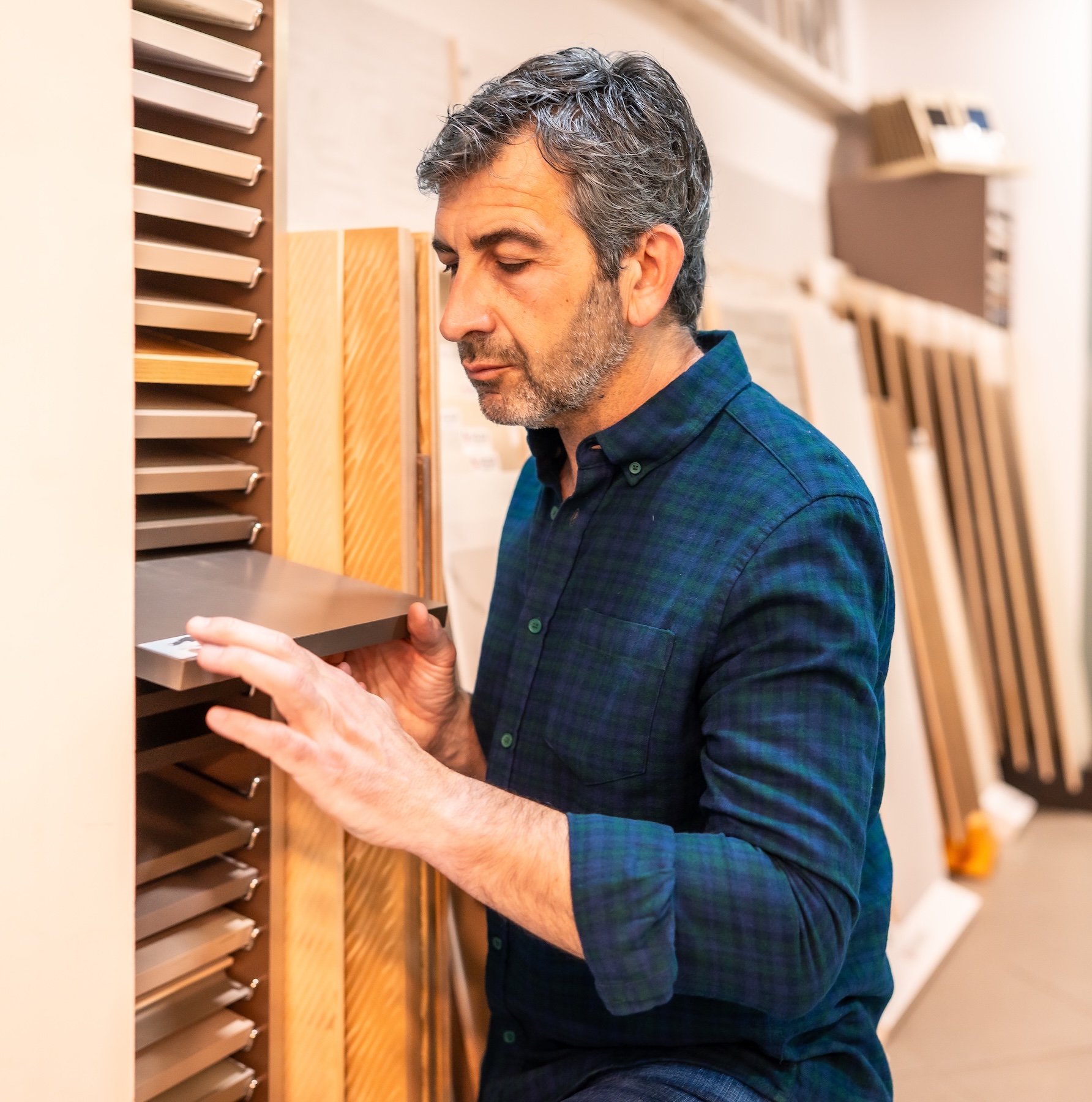 Carpenter choosing materials in a home improvement store A carpenter makes a selection of building materials